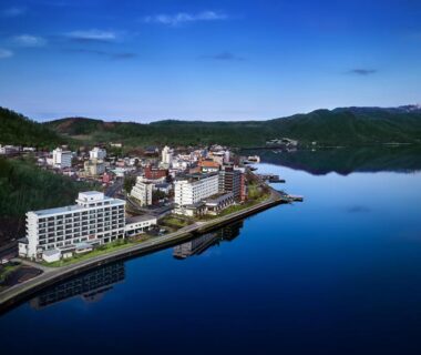 Aerial view of lakefront hotels and calm water near Toya-onsen Hotel Hanabi in Hokkaidō