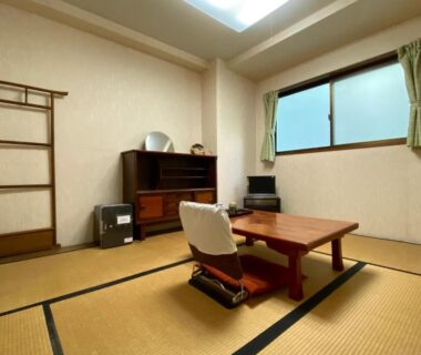 Tatami room with low table and floor chair at Toyofuku in Hyōgo, Kansai, Japan