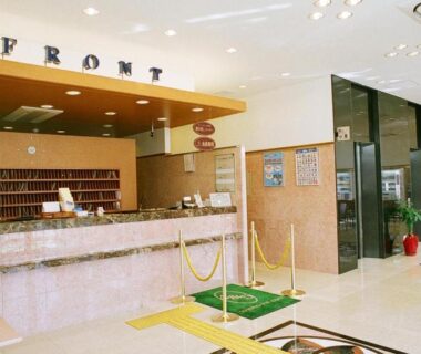 Front desk with key cubbies and flower arrangement at Toyoko Inn Maebashi Ekimae, Gunma