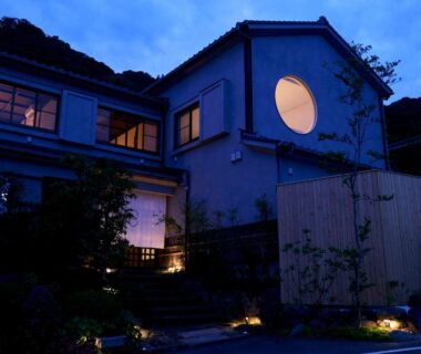 Exterior at dusk with lit circular window Tsuki to Maguro Ishigami Shizuoka