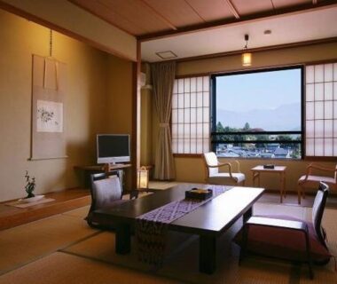 Tatami room with low table, shoji screens and distant mountain view at Tsukinoike, Yamagata, Tōhoku