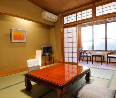 Traditional tatami room with low table, shoji screens and window seating at Tsuruya Ryokan in Hyōgo, Kansai