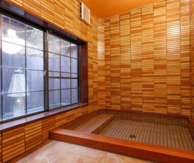 Indoor wooden bath with tiled floor and shoji window at Tsuruya Ryokan in Hyōgo, Kansai