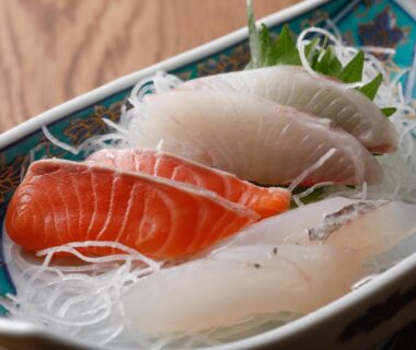 Salmon and white-fish sashimi on shredded daikon with wasabi in a decorative ceramic dish at Tsuruya Ryokan Hyōgo