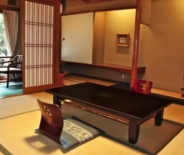 Traditional tatami room with low table, zabuton cushions, shoji screens and garden-facing veranda at Tsutaya Ryokan, Hyōgo