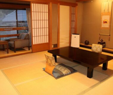 Traditional tatami room with low table, zabuton cushions and shoji screens at Tsutaya Ryokan in Hyōgo