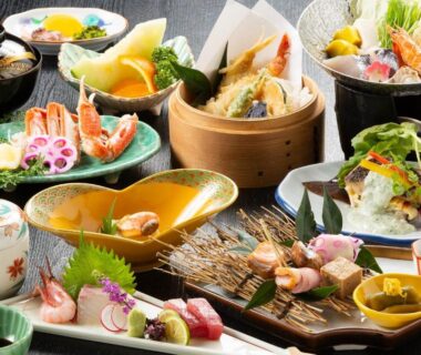 Assorted lacquered dishes and seafood on trays for a multi-course ryokan dinner in Hyōgo