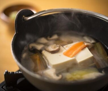Simmering tofu and mushrooms in a small pot at Tsutaya Tokinoyado Kazari, Nagano, Chūbu, Japan