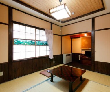 Traditional tatami room with low table and shoji screens at Tsuyukusa, Gifu