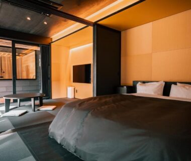 Modern tatami room with low bed and shoji screens at Umegashima Drive-In, Shizuoka
