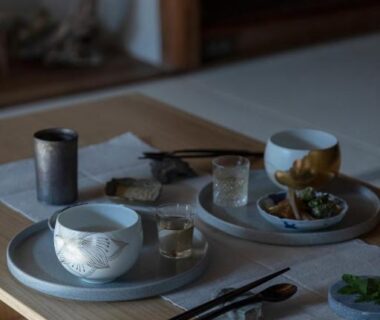 Low tatami table with tea cups, small dishes and chopsticks at UTAHI A Kyoto machiya