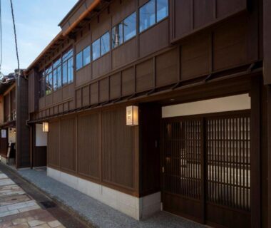 Two-story wooden façade with latticed entrance and lanterns at UTAIMACHI along a narrow street in Ishikawa, Chūbu