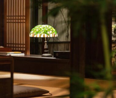 Tatami seating with low table, stained glass lamp and shoji screens at Ubusuna no Sato TOMIMOTO, Nara