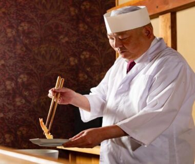 Chef in white uniform preparing dish at wooden counter, Ubusuna no Sato TOMIMOTO, Nara