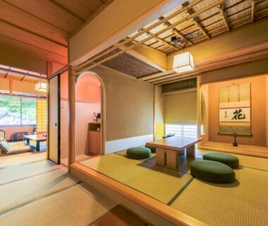 Traditional tatami room with low table, floor cushions, shoji screens and tokonoma at Uesugi no Miyu Gotenmori, Yamagata