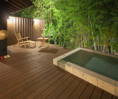 Wooden outdoor deck with soaking tub, lounge chairs and bamboo privacy screen at Ufufu in Shizuoka, Chūbu, Japan