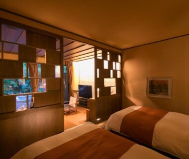 Tatami room with two beds, wooden lattice partition and sitting area at Ufufu, Shizuoka, Chūbu