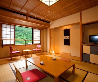Traditional tatami room with low table, shoji screens and garden view at Ukiha in Ōita, Kyūshū