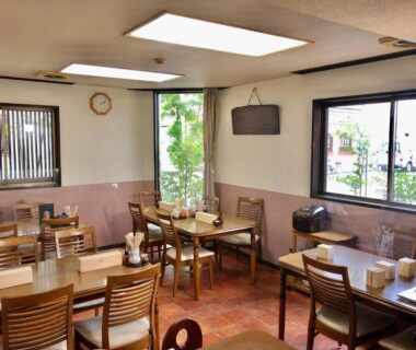 Wooden dining room at Umeoka Ryokan in Nagano, Chūbu with natural light and simple place settings