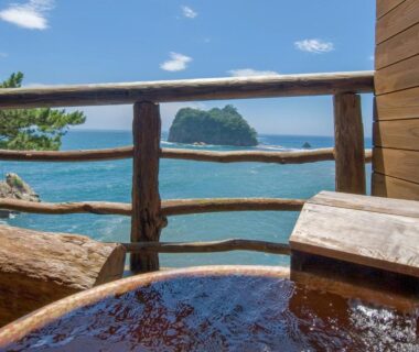 Wooden outdoor onsen tub with sea and island view at UmibenokakureyuSEIRYU, Shizuoka