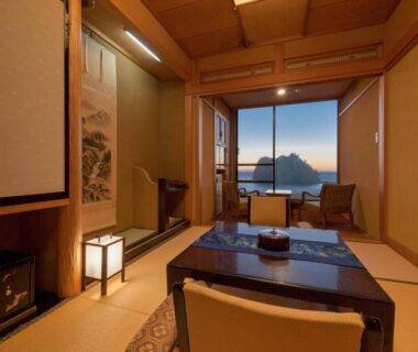 Tatami room with low table, shoji screens and sea view at Umibenokakureyu SEIRYU Shizuoka