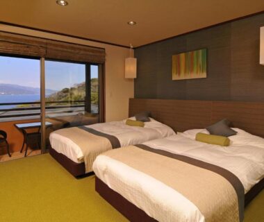 Tatami room with twin beds, balcony and sea view at Uminohana in Shizuoka