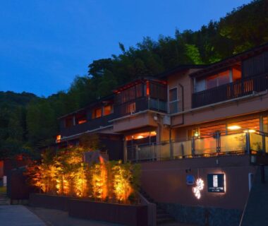 Evening illuminated exterior of Uminohana against wooded hillside in Shizuoka, Chūbu region, Japan