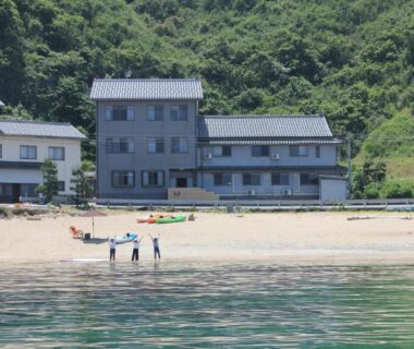 Beachfront Uminone building with kayaks and visitors on shore, Hyōgo, Japan