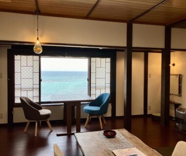 Sea-facing room with shoji screens, low table and seating at Uminone, Hyōgo, Kansai