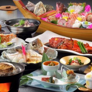Multi-course Japanese meal with sashimi boat, grilled fish and assorted side dishes at Uminoniwa in Chiba