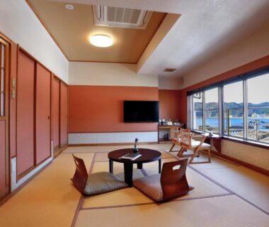 Sunlit tatami room with low table and zabuton at Uminoniwa in Chiba Kanto