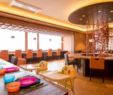 Bright ryokan dining room with booster seats and colorful tableware at Umiusagi in Shizuoka, Chūbu, Japan