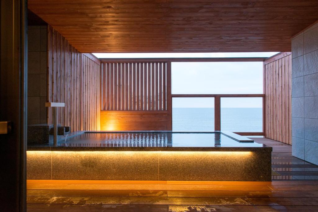 Wooden indoor bath Umiusagi Shizuoka Indoor wooden bath with large window and sea view at Umiusagi in Shizuoka, Chūbu region