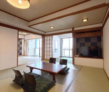 Tatami room with low table and shoji screens at Uomisaki Hotel in Shizuoka