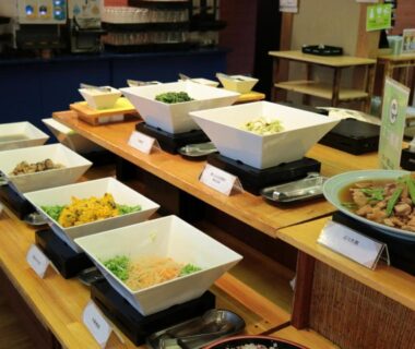 Assorted dishes in white bowls on wooden buffet counter at Uomisaki Hotel, Shizuoka, Chūbu Japan