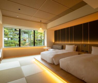 Bright tatami room with twin beds, low wooden platform and garden view at Urakusatsu TOU, Gunma, Kantō, Japan