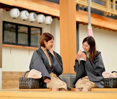 Two guests in yukata seated on a wooden porch at Urakusatsu TOU, Gunma, Kantō, Japan