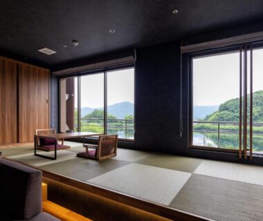 Modern tatami seating area at Urari Takeo with low table and windows facing verdant hills in Saga