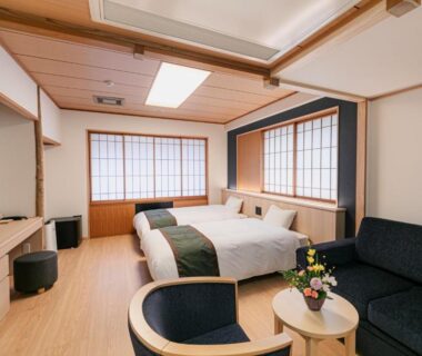 Twin beds, shoji screens, seating area with table at Ureshino Motoyu in Saga, Kyūshū, Japan