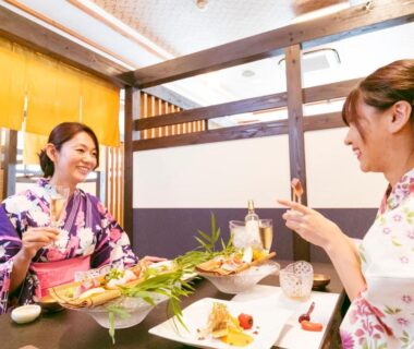 Two women in yukata enjoying a meal in a ryokan dining room at Ureshino Motoyu, Saga, Kyushu, Japan