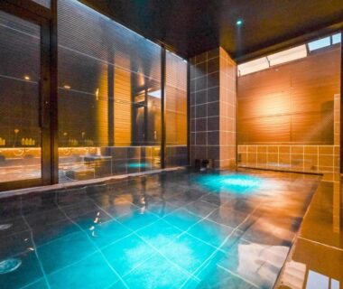 Indoor onsen bath with tiled floor and wooden wall panels at Ureshino Onsen Yadoya Uchiroji, Saga