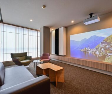 Lounge with sofa, armchairs and large projection screen by shoji window at Ureshino Onsen Yadoya Uchiroji in Saga