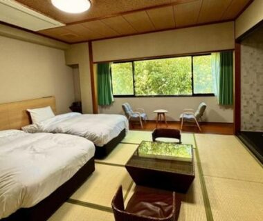 Tatami room with twin beds and low table at Ureshino Onsen Yusyuku Sarayama in Saga, Kyushu, Japan