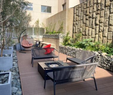 Outdoor terrace lounge with woven sofas, hanging chairs and low tables at Ureshino Onsen Yusyuku Sarayama in Saga