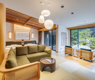 Bright tatami lounge with sofa, low table and garden view at UreshinoOnsen URESHINO YADOYA in Saga, Kyūshū, Japan