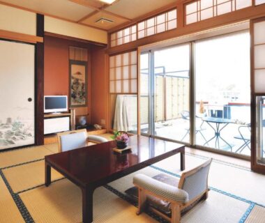 Traditional tatami room with low table, shoji screens and balcony at Uruoikan in Nagano Chūbu