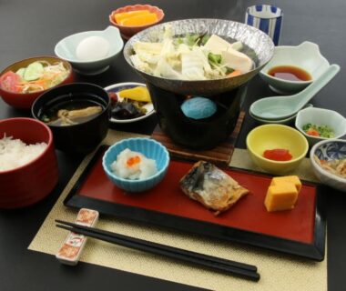 Traditional Japanese breakfast with simmering pot, rice, grilled fish and side dishes at Usuki Yunosato, Ōita