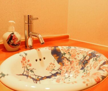 Decorative ceramic sink with floral motif and chrome faucet in a Usuki Yunosato bathroom, Oita, Kyushu, Japan