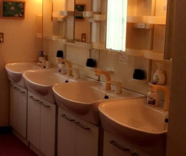 Row of washbasins and mirrors in ryokan washroom at Village Sun Lake Kawaguchiko, Yamanashi, Chūbu