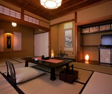 Traditional tatami room with low table and floor cushions at Wafu-no-Yado MASUYA in Nagano